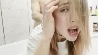 A guy fucks a girl in the ass near a washing machine.