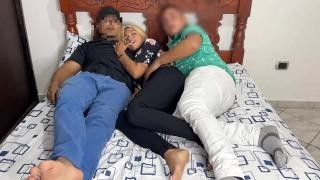 The guys and the blonde are lying and fucking on a large bed.