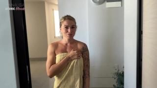 A wife in a towel gives her husband a blowjob