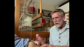 An elderly man gives his grandson a blowjob