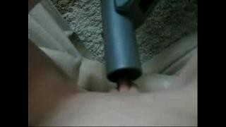 Blonde plays with a vacuum cleaner