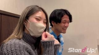 A Japanese couple walks down the street with a journalist.