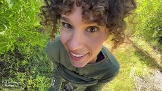 A guy and a girl are having sex outdoors