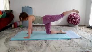 A young brunette is doing physical exercise