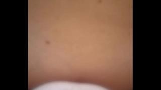 Curly-haired brunette with big tits gives a blowjob