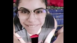 A naked brunette gives her boyfriend a blowjob.