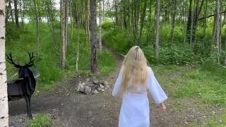 A blonde is walking in nature