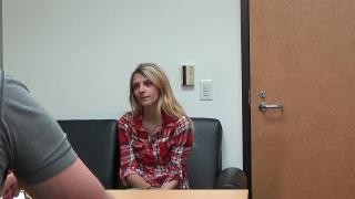 A man at a table is talking to a blonde