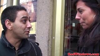 A guy is talking to a mature woman on the street