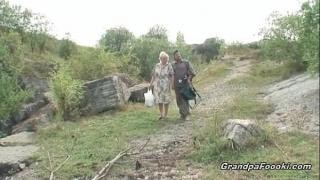 A blonde stripped naked near an elderly couple.