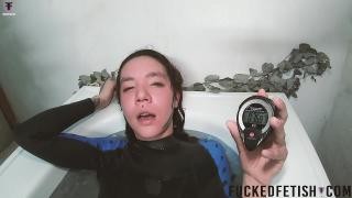 A skinny Asian woman takes a bath