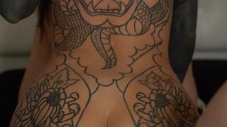 A guy roughly fucks a tattooed brunette in the ass